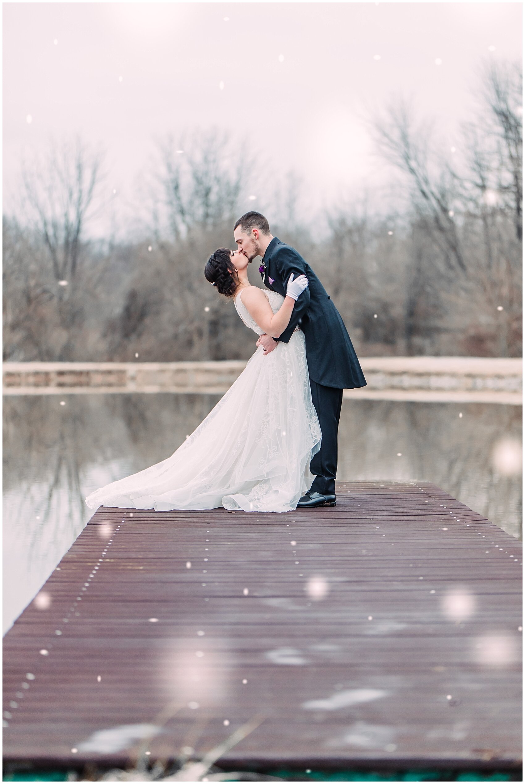 bride and groom kissing on a lake 