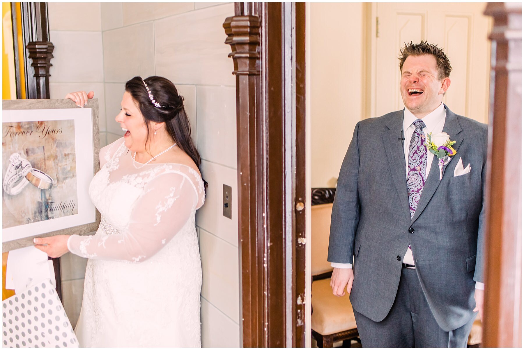a bride and groom laughing before their wedding at fowler house mansion holding a picture of their wedding bands