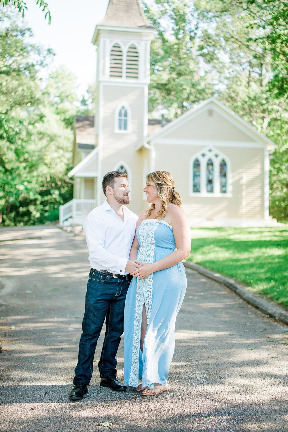 a couple standing in front of a chapel
