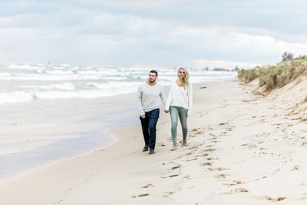 man and woman walking on a beach 