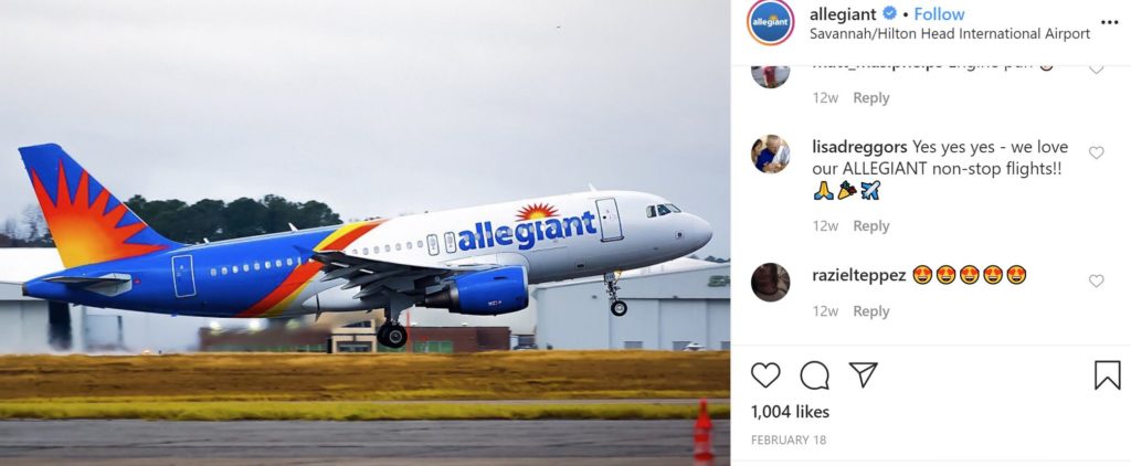 my favorite airlines allegiant air airplane taking off with buildings in the background
