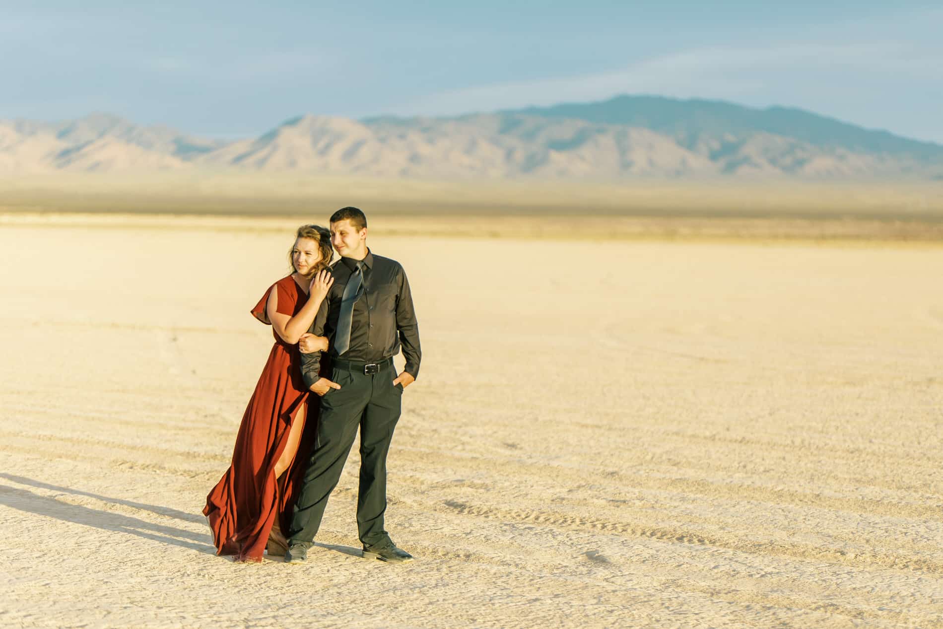 couple standing in desert for engagement