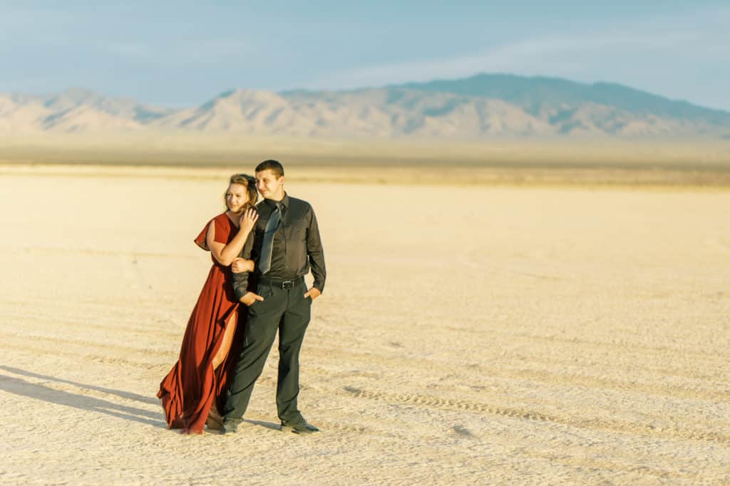 couple standing in dry lake bed in las vegas