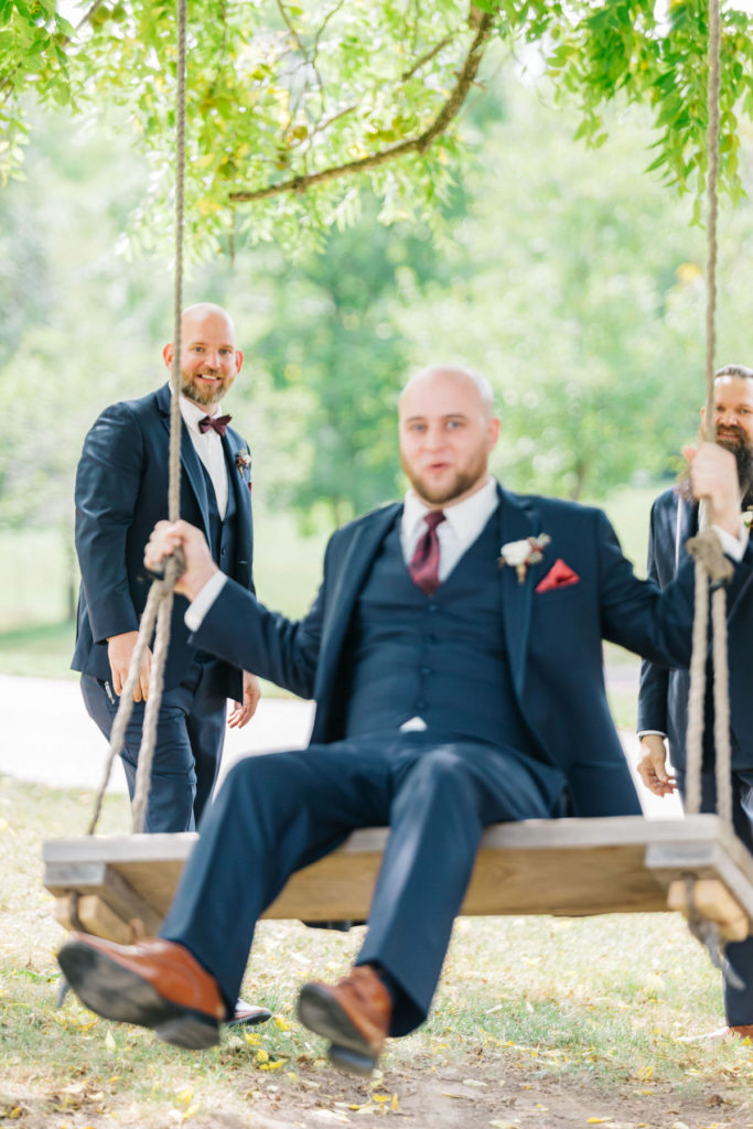 groomsmen portraits on swing