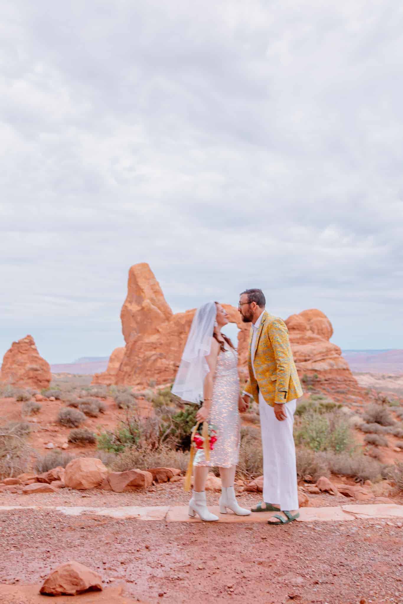 sunrise at arches national park with bride and groom