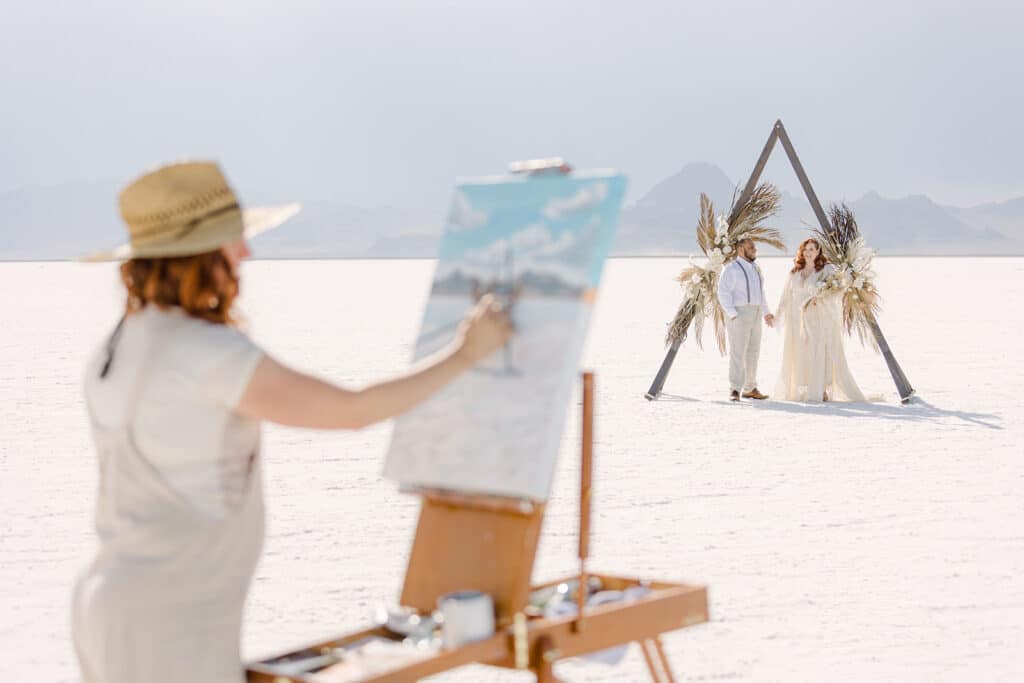 live wedding painter at the bonneville salt flats with couple in background